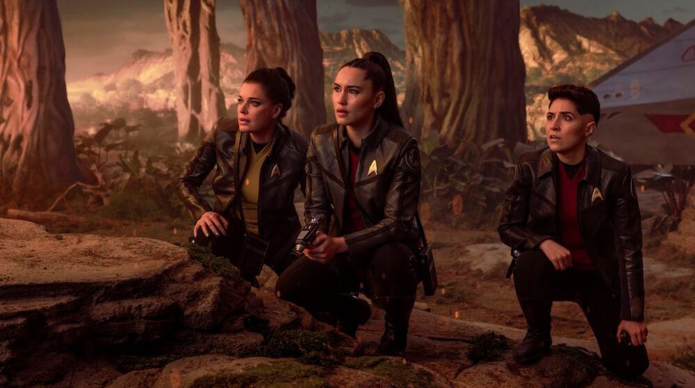 Una, La'an and Ortegas looking at something in awe with a shuttlecraft parked behind them